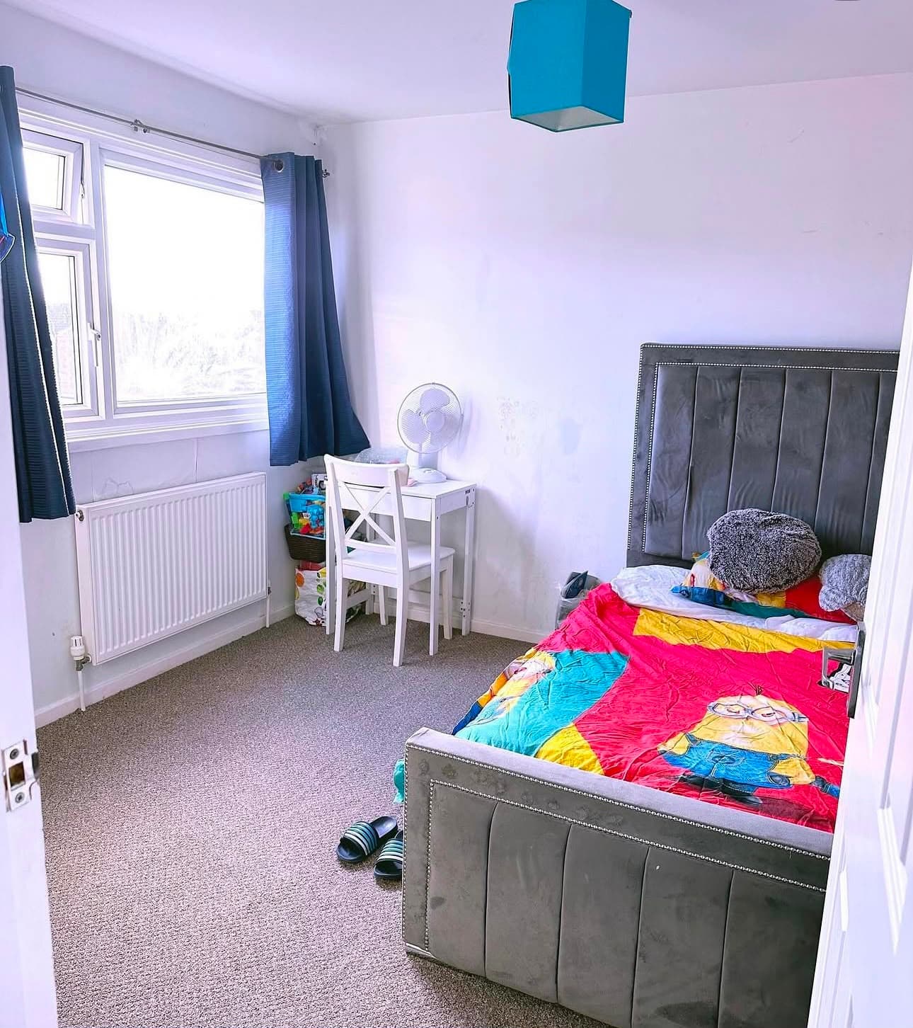 After — the same bedroom made up, with the floor clear